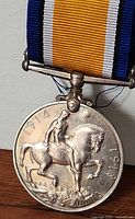 Full view of medal reverse with ribbon attached