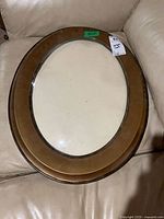 Front view of oval wood frame with convex glass