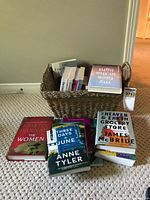 Stacked hardcover books and wicker basket showing titles and overall quantity