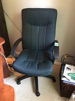 Front view of padded swivel office chair showing upholstery, armrests, and base