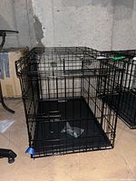 Overall view of assembled black metal wire pet crate with plastic base