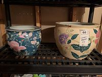 Both floral ceramic planters on shelf