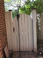 Full view of shepherds hook leaning against white gate