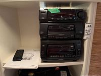 Stacked Panasonic stereo components with manual and remote
