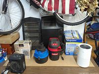 All items grouped on table: heaters, vacuums, humidifier box, air purifier