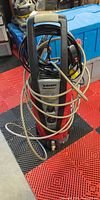 Full view of Husky electric pressure washer with hose and cord coiled