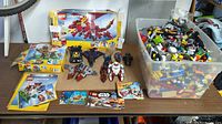 Overall lot showing bin of Lego bricks, Creator set box, assembled models and manuals