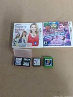Group shot showing two cased 3DS games and four loose cartridges