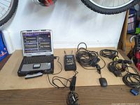 Overall lot showing Toughbook CF-30, MUT-III unit, cables, mouse, power adapter