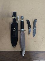 Overall view of three knives and sheath