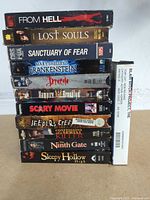 Front spines of stacked VHS tapes showing titles