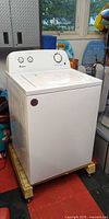 Full front view of Amana top-load washing machine on dolly