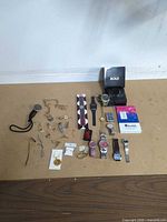 All items laid out showing watches, jewelry, lighter