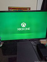 Console displaying Xbox One boot screen on monitor