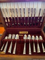 Open flatware chest showing knives and spoons