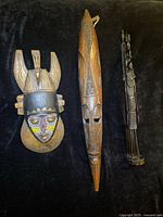 Full view of three African carved wood items