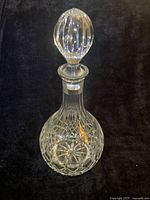 Full view of crystal decanter with stopper