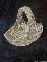 Side view of cut glass basket showing handle and patterns