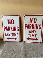 Both NO PARKING ANY TIME metal signs front view