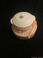Brie baker with lid on box beside wooden spatula