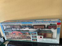 Front of boxed Dickensville Christmas Train/Station with Sound set showing train cars and station