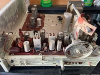 Overall view of Philips amplifier chassis with tubes, dial mechanism, transformer