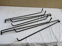 Four black metal hairpin legs on white cloth