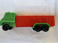 Left side view of green cab and red trailer showing PEZ logo
