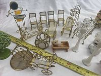 Group shot showing brass wire furniture, lamp posts, cradle with plush dog