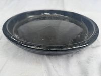 Large black-glazed clay saucer top view