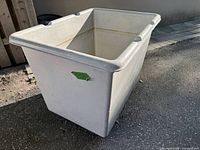 Front angled view of grey plastic bin showing wheels and exterior condition