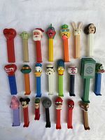 All 22 PEZ dispensers laid out on cloth