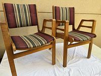 two wooden stackable chairs side by side