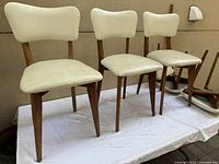 Three upright chairs showing design and upholstery