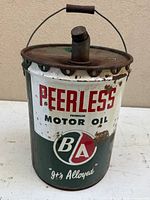Front view of BA Peerless oil can showing logo and text