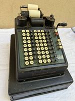 Full view of Burroughs Portable cash register showing keys and paper roll holders