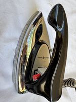 Close-up of iron showing chrome body and handle