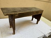 Full view of wooden bench on white backdrop