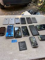 Group shot showing all phones, brands and loose battery on table