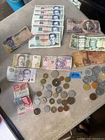 Overview of all banknotes and coins spread on table