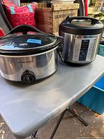 Hamilton Beach slow cooker and Midea rice cooker on table