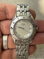 Front view of ESQ watch showing dial, bezel, bracelet links