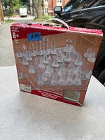 Front of retail box showing glass chess and checkers set