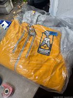 Jacket in sealed bag showing front and embroidered Grey Cup Festival logo