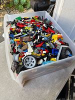 Top view of bin showing mixed LEGO pieces such as wheels, bricks, Technic parts
