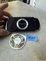 Back view of black Sony PSP with circular PSP logo alongside Star Wars Battlefront UMD