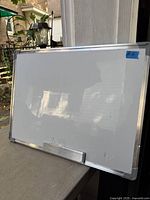 Front view of aluminum-framed whiteboard showing surface, frame and pen tray
