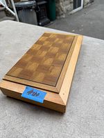 Closed folding wood chess board showing inlaid squares and taped lot number