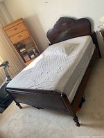 Full view of queen bed frame with mattress showing headboard, footboard and side rails