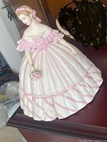 Front view of Capodimonte porcelain figurine showing dress, bouquet and overall condition